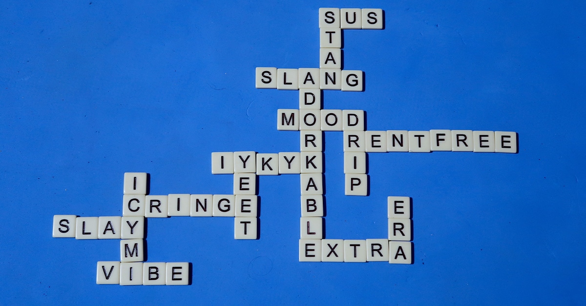 American English slang. Spelled with letter tiles on a blue background. Crossword style pattern of popular slang. Word puzzle.