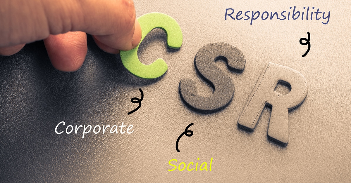 Closeup hand arrange wood letters as CSR abbreviation (Corporate social responsibility)