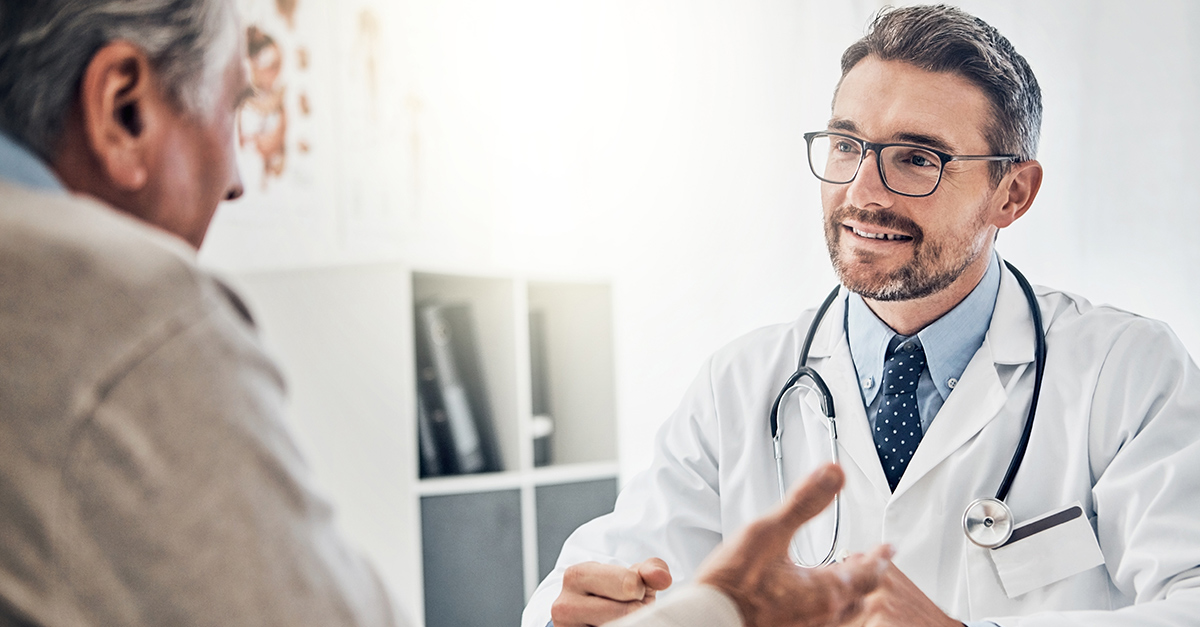 Male doctor consulting with Hispanic male patient