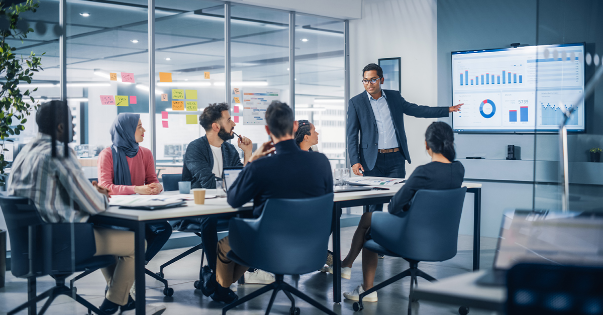 Presentation meeting of diverse global team members in a corporate conference room