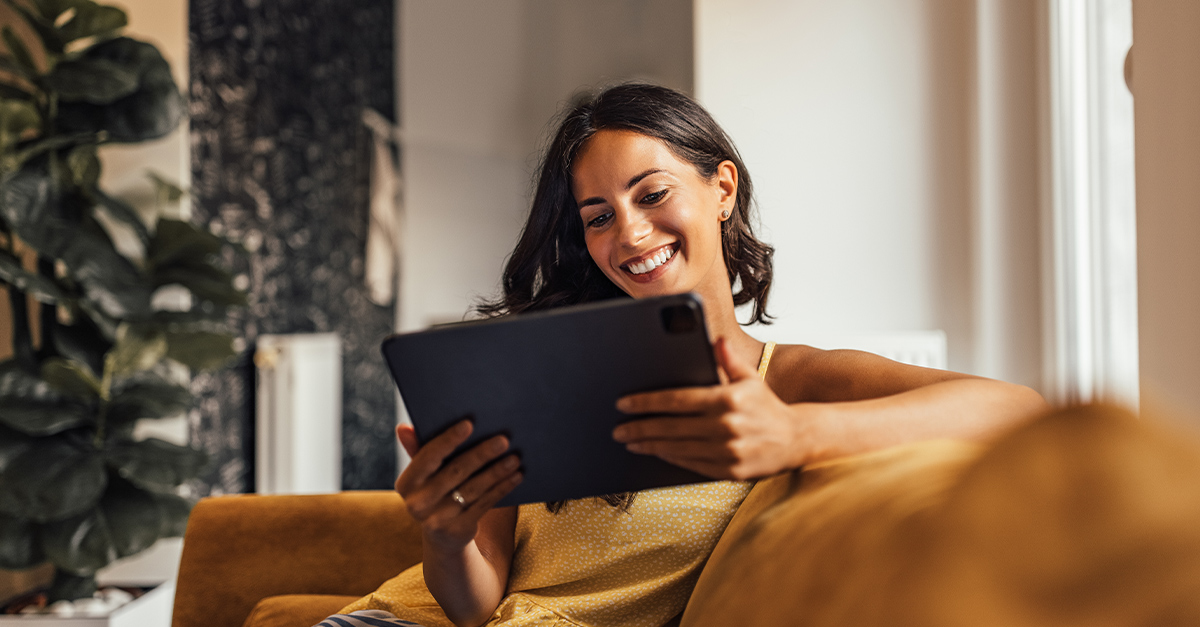 Woman learning business English by watching YouTube on her tablet