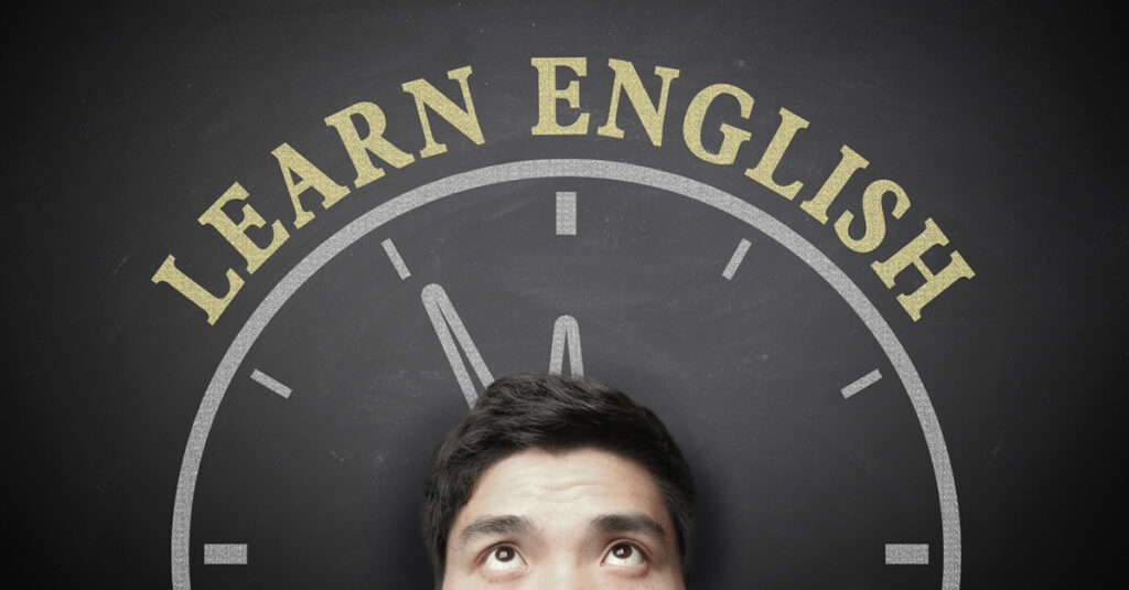 The language learning concept of Time To Learn English for English Education. Cropped image of a man's head looking up with a chalkboard behind him showing part of a clock and the words "Learn English"