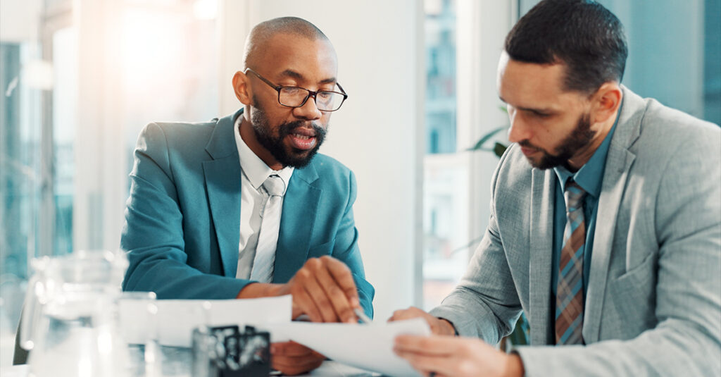 Manager micro-coaching employee in a modern office setting