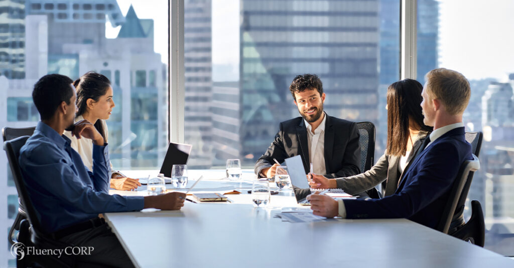 International multiethnic professional business meeting in corporate board room, illustrating the blog topic of How To Prepare for an International Business Meeting