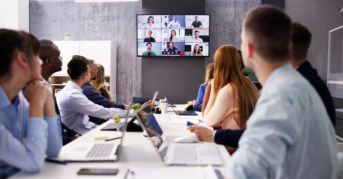 Corporate meeting with video conferencing, illustrating the blog topic "Eliminating Language Barriers in Hybrid Teams: English Communication Strategies That Work"
