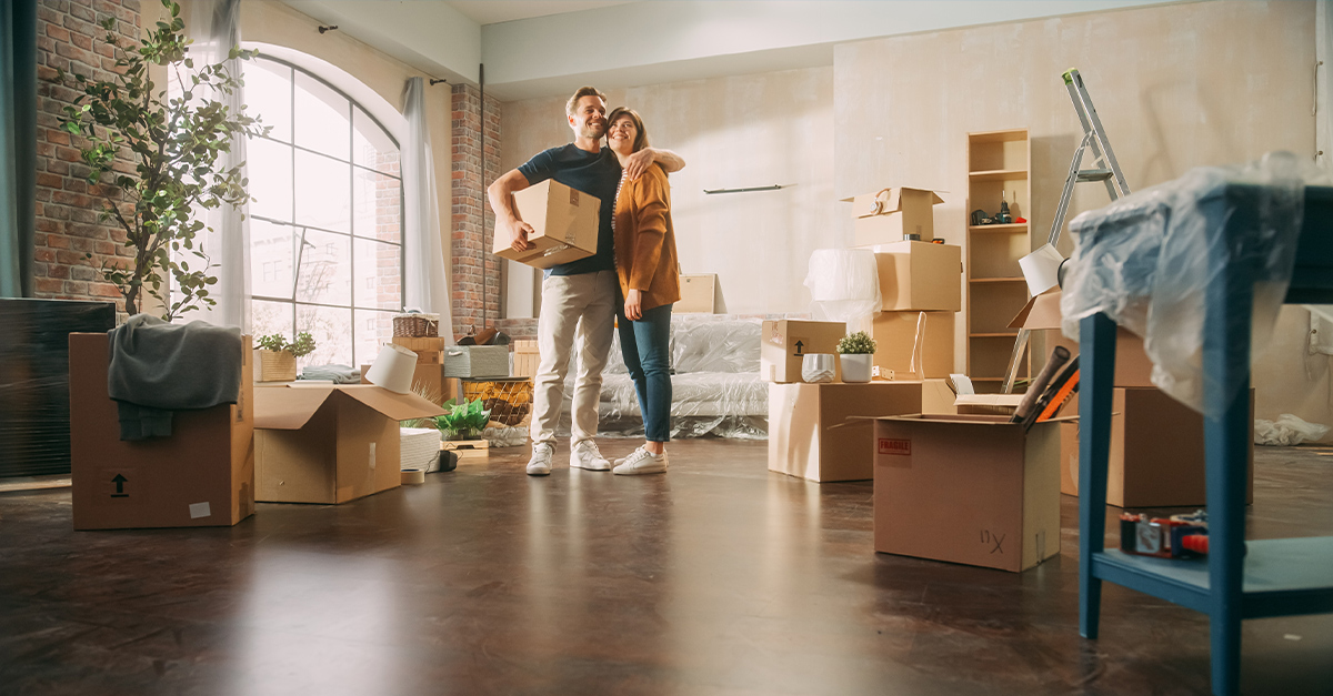 Happy couple moving into a new home, illustrating the blog topic "How to Learn a New Language Before You Move: Your Complete 30-Day Plan"