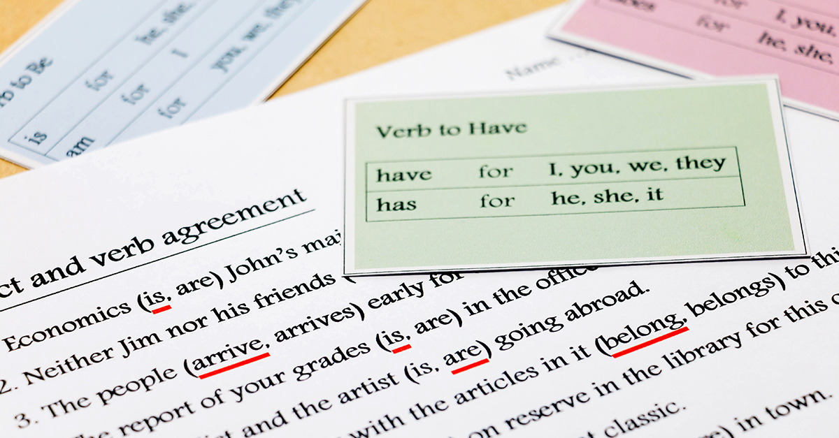English grammar exercise with grammar cards on table showing common English grammar mistakes