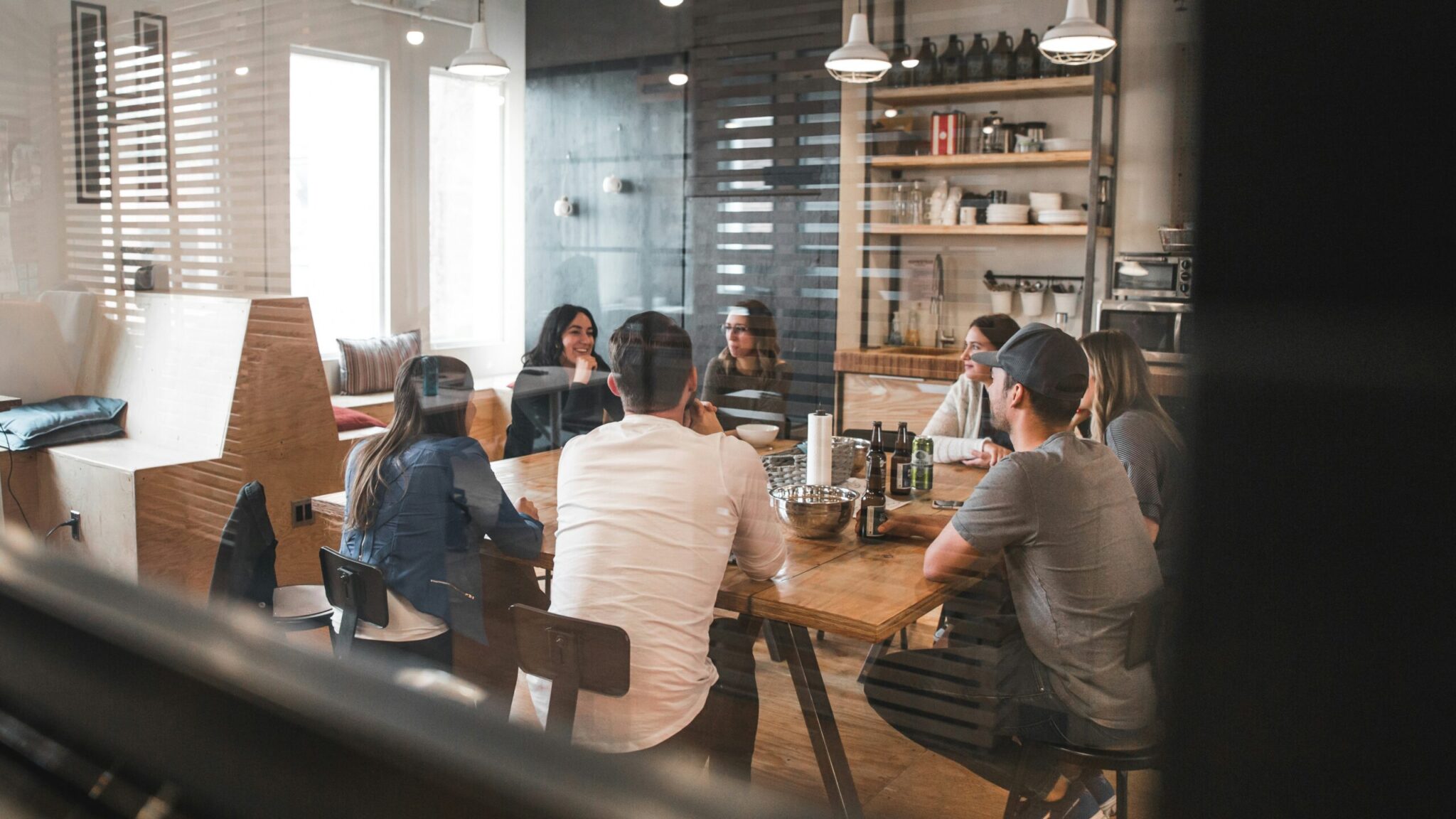 Friendly office showing employees engaging to illustrate the post: Employee Retention and Engagement: And How Language Training Boosts it