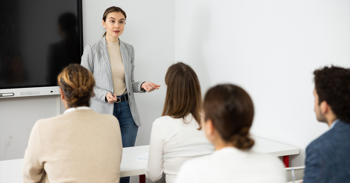 Female professional leading corporate language training in an office.