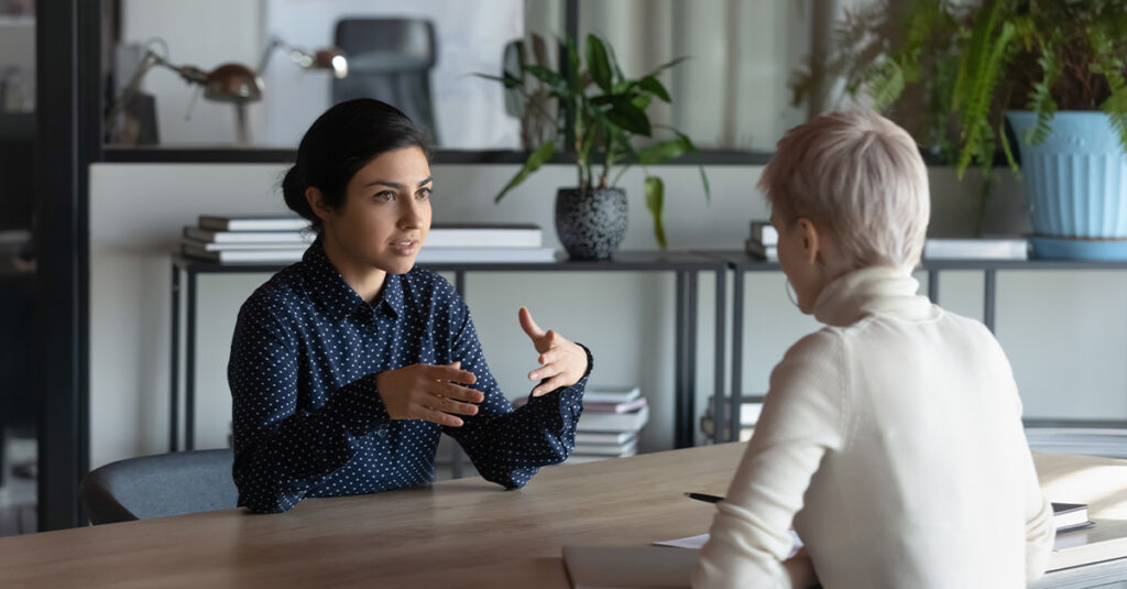 Woman speaking with her employer and asking for workplace language training